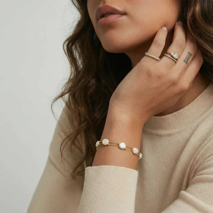 Baroque Pearl Layered Bracelet with creamy irregular pearls and polished gold beads on a delicate gold-tone chain