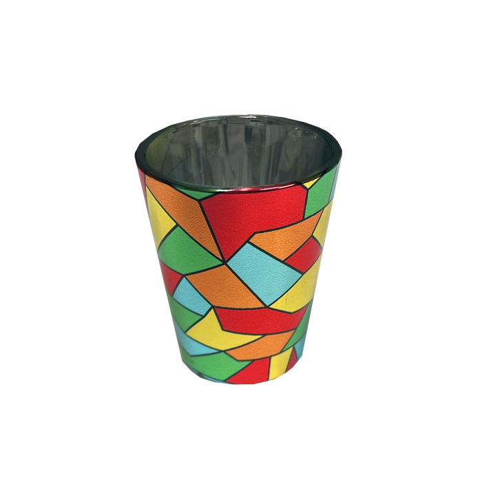 Introducing the Oakland Roots SC Mosaic Shot Glass: a tapered metallic shot glass showcasing a vibrant, abstract geometric mosaic design with interlocking shapes in red, yellow, blue, and green. The silver rim and reflective silver interior perfectly capture the spirit of the Oakland Roots Sports Club.