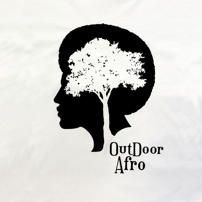 The "Outdoor Afro Signature Tee" by Partner features a unique graphic with a black silhouette of a woman's face in profile, where her hair transforms into an intricate tree with branches and leaves. To the right of the silhouette, the text "Outdoor Afro" is prominently displayed in black lettering against a white background, making it an ideal choice for an outdoor-themed t-shirt.