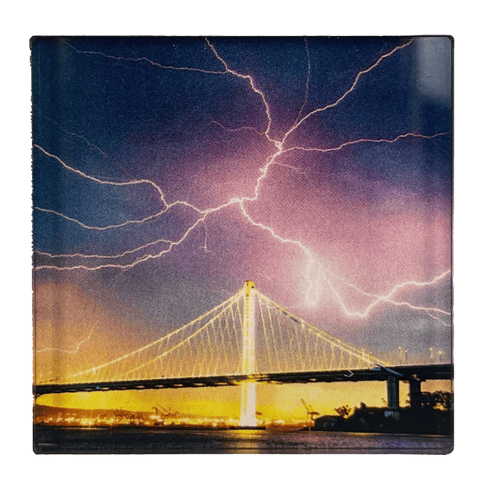 Image of lightning in night sky over Oakland bridge by photographer Vincent James.
