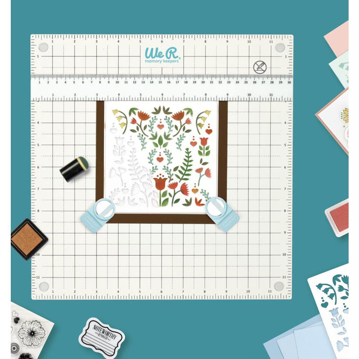 We R Memory Keepers - All-In-One Magnetic Platform. The All-In-One Magnetic Platform is perfect for stenciling, aligning, embossing, and cutting. One side is an easy-clean work surface. Available at Embellish Away located in Bowmanville Ontario Canada.
