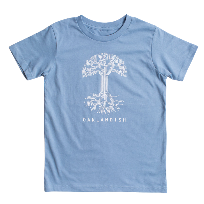 The Youth Oaklandish Classic Logo Tee from Oaklandish is a Carolina blue t-shirt featuring a white graphic of a tree with branching lines resembling roots and branches. Below the tree design, the word "OAKLANDISH" is printed in white. Made of 100% cotton, this youth t-shirt is displayed on a plain white background.