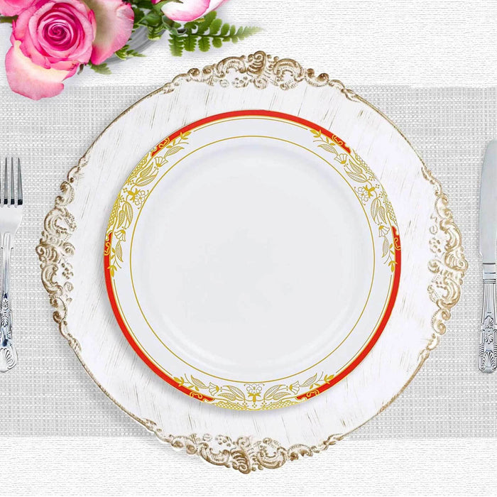 Elegant white plate with decorative gold and red border on ornate charger.