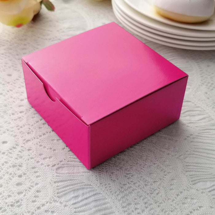 Pink gift box with a glossy finish on a lace tablecloth.