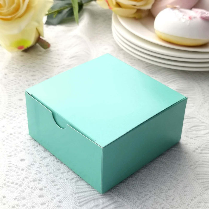 Turquoise gift box on a textured white tablecloth