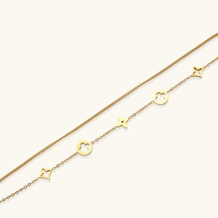 18K Gold-Plated Clover bracelet with two fine gold-tone chains, open quatrefoil clovers in circles and four-point star charms