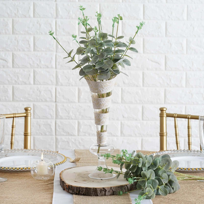 Elegant faux eucalyptus arrangement in a decorative vase for table decor.