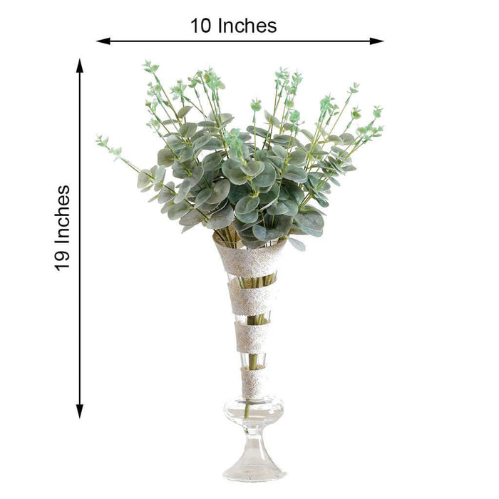 Artificial eucalyptus flower arrangement in glass vase, 10x19 inches.