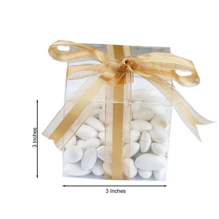 Clear gift box filled with white candies and a gold ribbon, 3 inches in size.