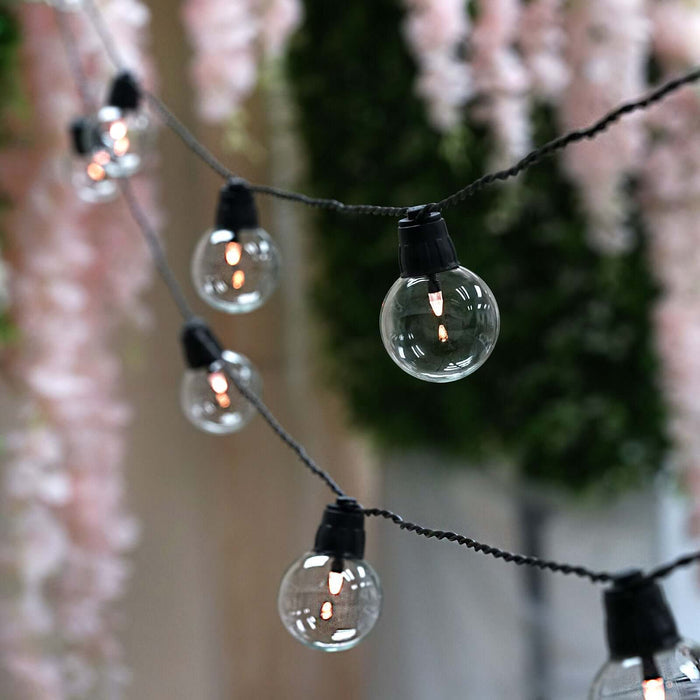 String of decorative clear globe lights with a black cord.