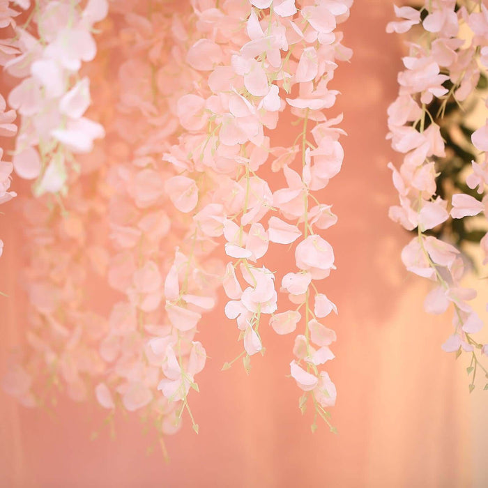 Delicate pink flower garlands hanging elegantly against a soft background.