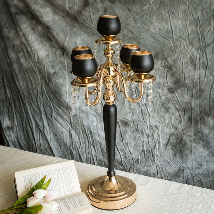 Elegant gold and black candelabra with crystal accents, perfect for decor.