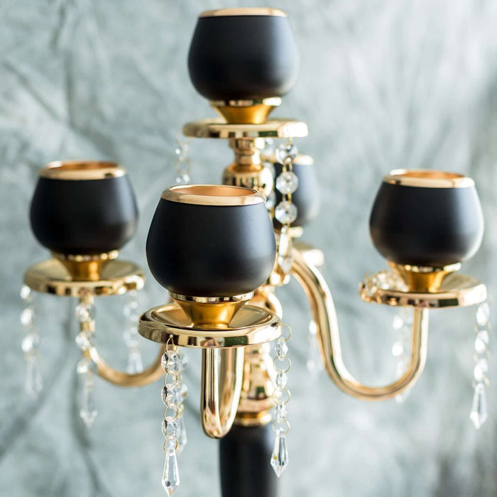 Elegant black and gold candelabra with crystal accents.
