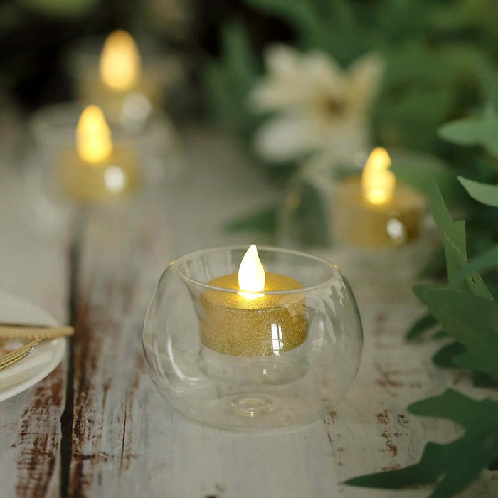 LED tealight candle in glass holder with gold glitter. Perfect for ambiance.