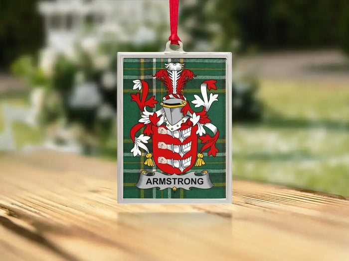 Armstrong family crest Irish tartan ornament on tree — polished metal frame, satin ribbon hanger