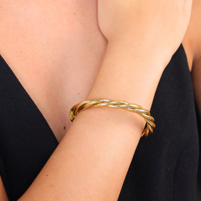 a woman wearing a gold bracelet