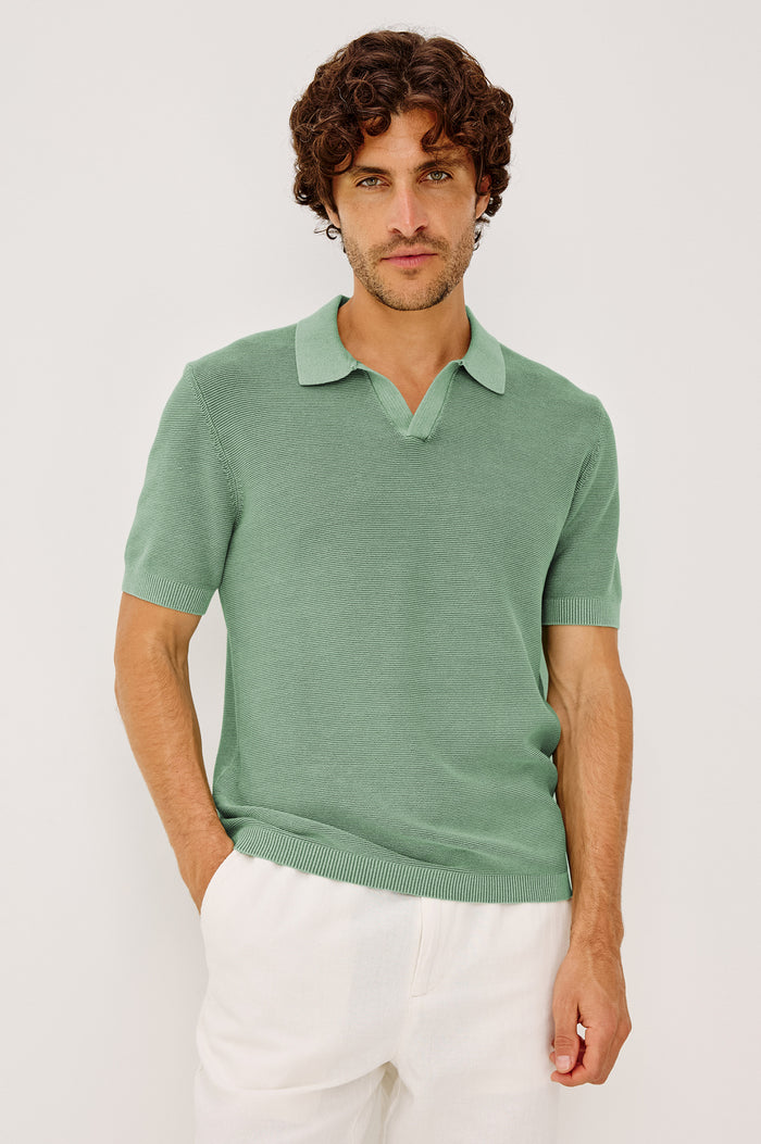Baker Polo Shirt in Rib Cotton Knit With Colar, Short Sleeves, and Relaxed Fit in Vetiver Colorway - Upper Body Front View Featured on Model