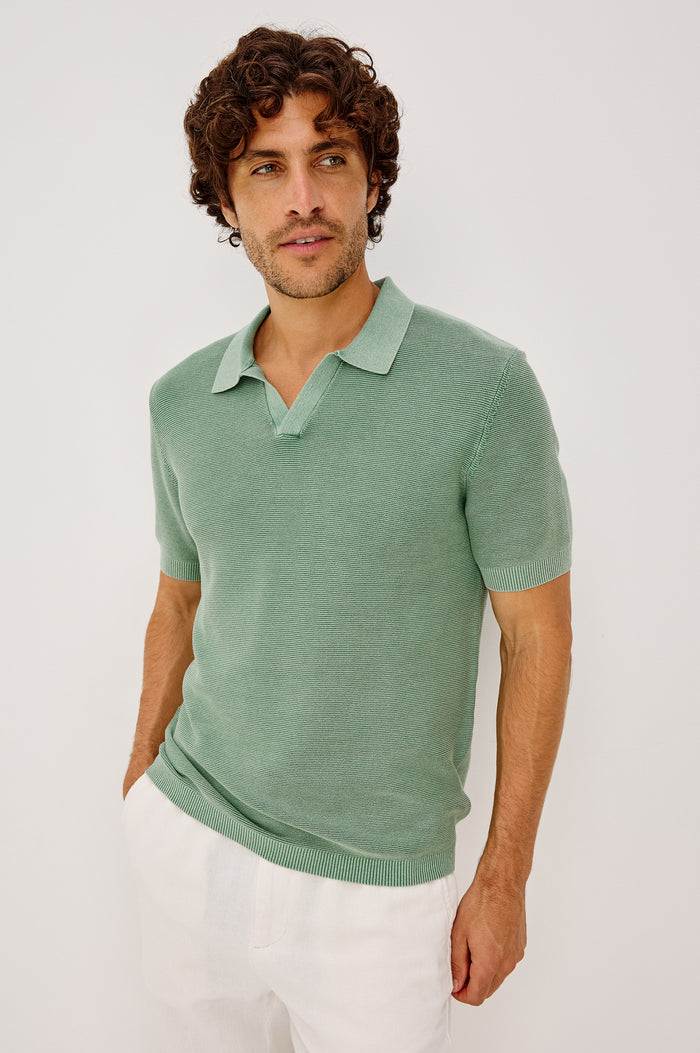 Baker Polo Shirt in Rib Cotton Knit With Colar, Short Sleeves, and Relaxed Fit in Vetiver Colorway - Upper Body Front View Featured on Model