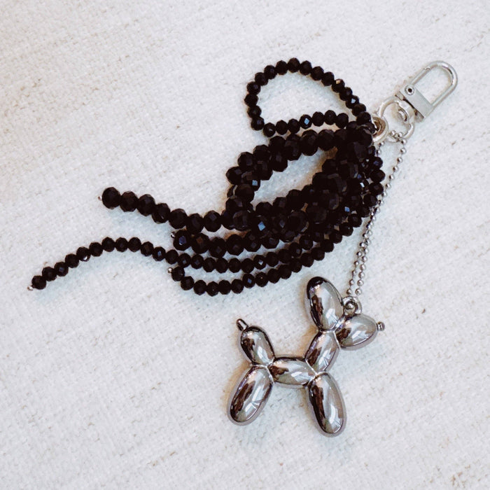 Ellison+Young balloon dog bag charm with beaded bow, playful and colorful accessory for handbags and backpacks.