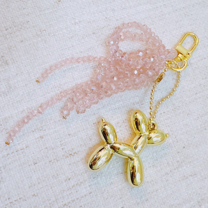 Ellison+Young Balloon Dog Bag Charm with beaded bow, decorative accessories for handbags featuring colorful balloon dog design.