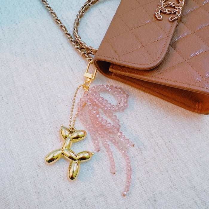 Ellison+Young Balloon Dog Bag Charm with beaded bow, decorative accessory for handbags featuring colorful balloon dog design