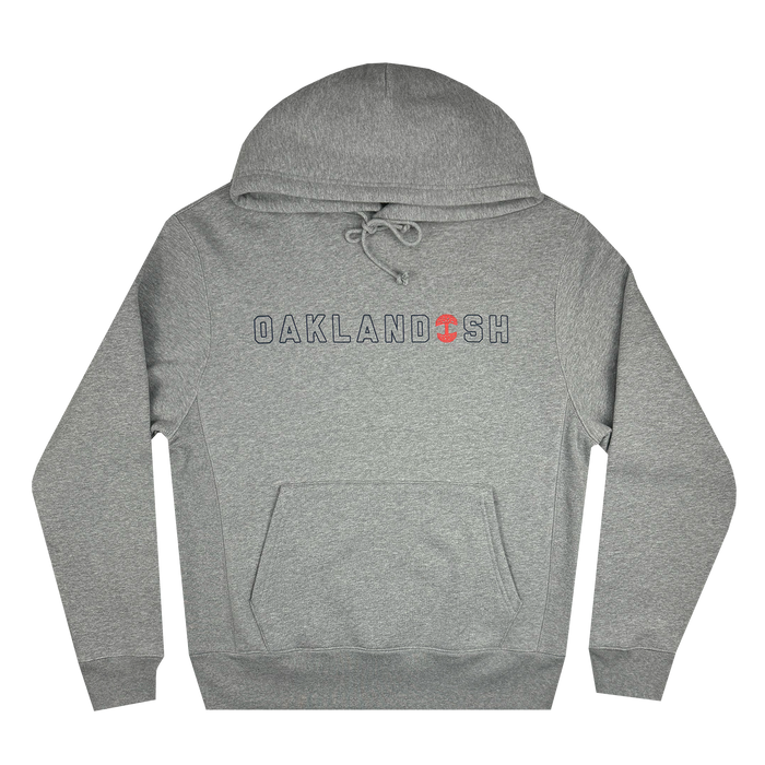 The Bandit Hoodie from Oaklandish is a heather grey pullover that showcases "OAKLANDISH" in bold letters across the chest, with a small red tree symbol substituting the letter "A." It features an adjustable drawstring hood and a front kangaroo pocket, designed for men's sizing. The hoodie is displayed flat against a white background.