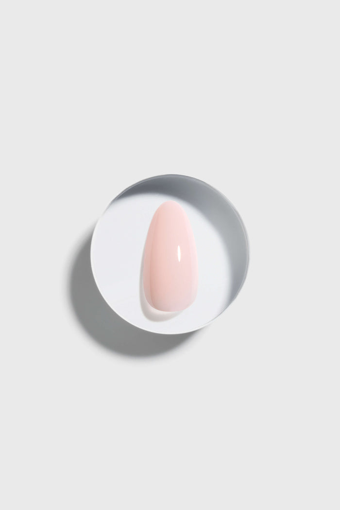 Pink press-on nail on a white background