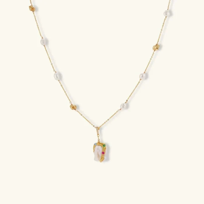 Baroque Bloom Freshwater Pearl necklace with irregular white pearl pendant, gold-tone chain, and colorful zirconia accents.