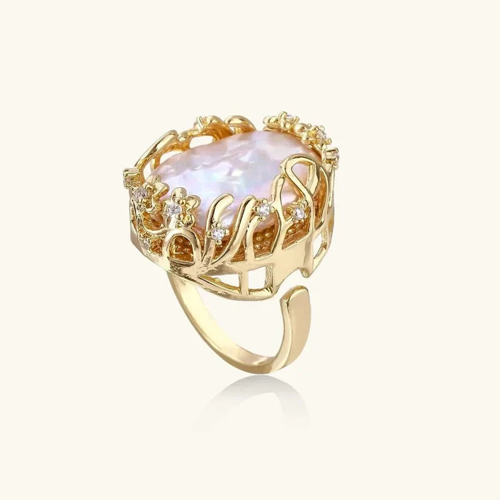 Baroque Freshwater Pearl ring with an irregular iridescent pearl, gold-tone openwork crown setting and clear crystal accents