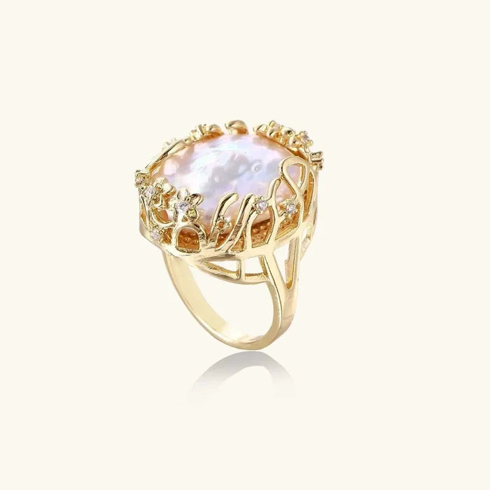 Baroque Freshwater Pearl ring with a luminous irregular pink-white pearl in a gold-tone openwork crown setting with clear accents.