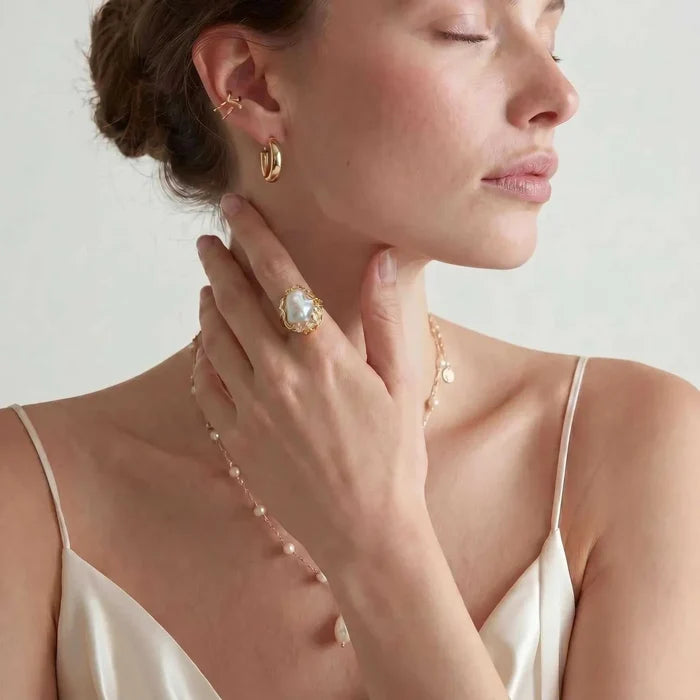Baroque Freshwater Pearl ring with an irregular white pearl, gold-tone crown setting and clear crystal accents