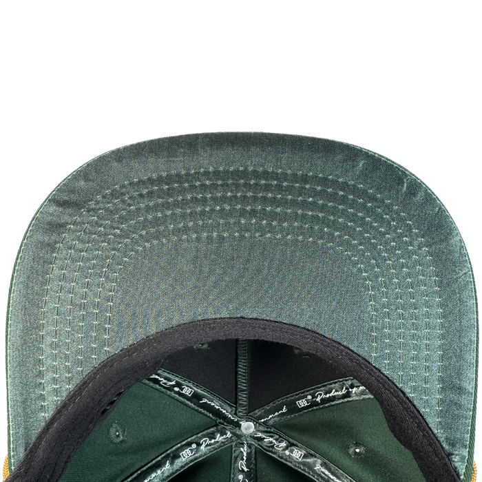 Close-up of the Bay Area 5 Panel By DOC by Oaklandish: shows the underside of its green brim with neat parallel stitching, black interior lining featuring white printed text, and a silver button at the crown center.