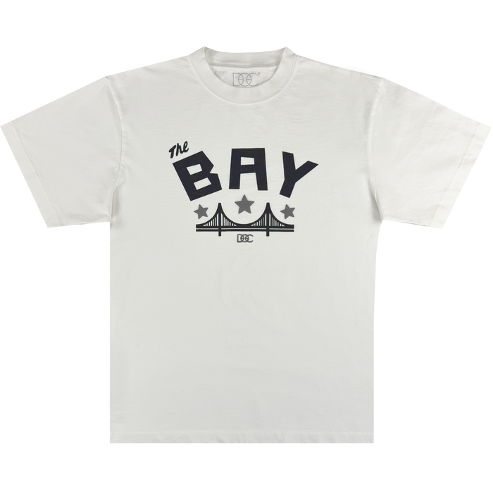 The Bay Bridge Tee By DOC V2 from Oaklandish features a classic fit in heavyweight cotton, with bold black "The BAY" text above a stylized bridge, two black stars, and a small rectangular logo below.