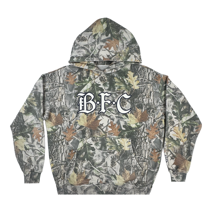 The Bay FC Camo Hoodie is a men's pullover with a wood camo pattern, bold white "BFC" chest lettering, front pocket, long sleeves, and a cozy hood. Brand: Bay FC.