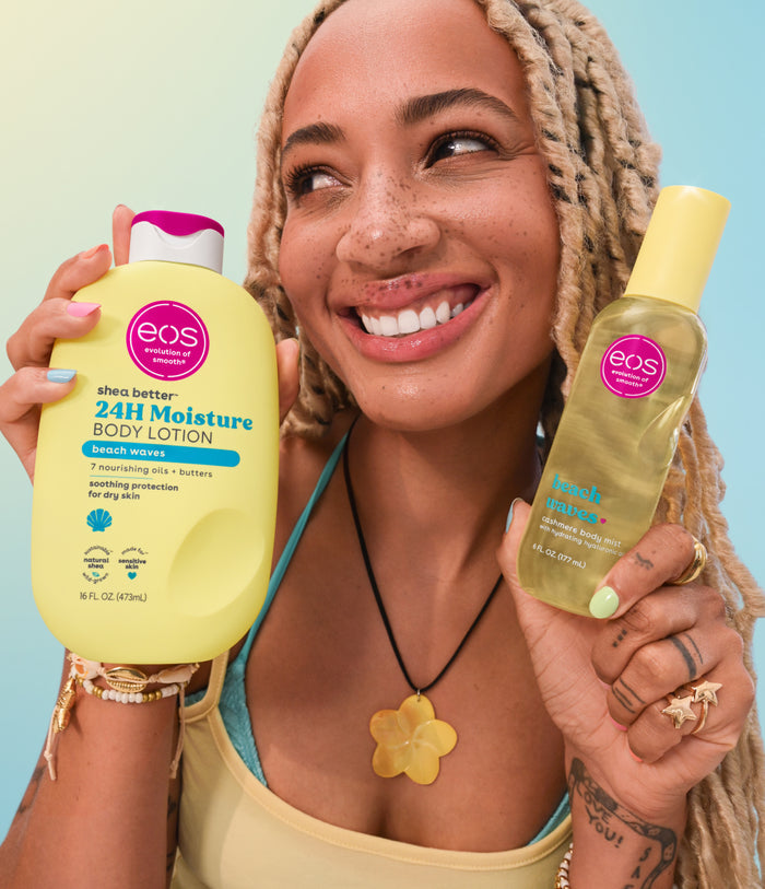 Woman holding two EOS products against a blue background