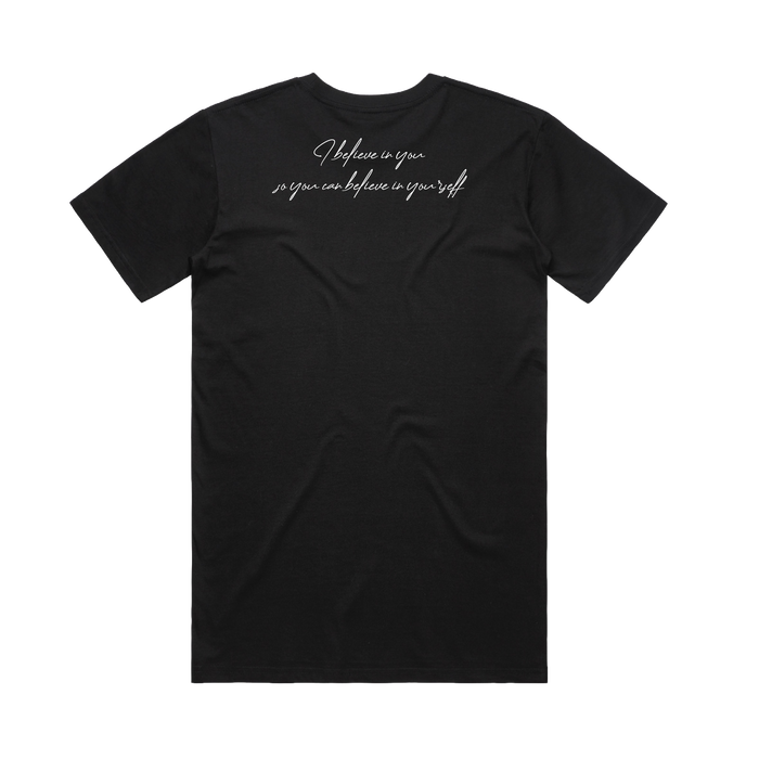 The Coach Beam's Legacy Tee by Other is a black short-sleeve shirt shown flat from the back. Across the upper back, white cursive reads “I believe in you so you can believe in yourself,” honoring the Coach Beam Legacy. No other designs or logos.