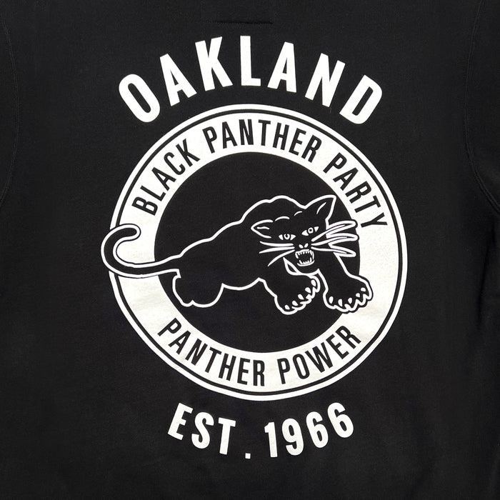 The Black Panther Power Hoodie by Oaklandish features a circular logo on a black background that reads "OAKLAND" in large white letters at the top. Inside the circle is a fierce black panther with bared teeth and claws, surrounded by the phrases "BLACK PANTHER PARTY" and "PANTHER POWER." At the bottom, it bears the inscription "EST. 1966". This design makes for an ideal pullover hoodie.