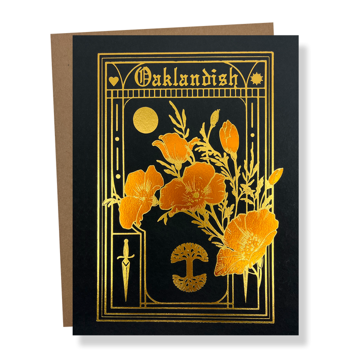 The Blossom Card by Never Elsewhere features a black background adorned with gold foil accents. Intricate designs on the card include flowers, a crescent moon, a dagger, and a fan-like motif, with "Oaklandish" elegantly written at the top in a stylized font. The card comes layered on a recycled kraft paper envelope.