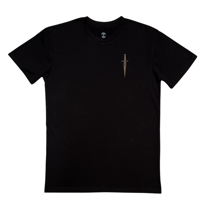 The Blossom Tee by Oaklandish is a plain black men's cotton t-shirt featuring a small embroidered design of a dagger on the left chest area. The background is white, emphasizing the minimalistic and stylish design of the t-shirt.