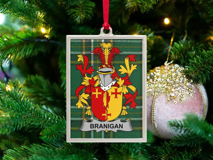 Branigan Irish family crest Christmas ornament — crest on the Irish national tartan in a silver-tone frame