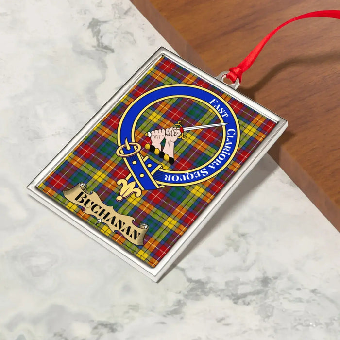 Buchanan ornament hanging from a Christmas tree branch by its satin ribbon