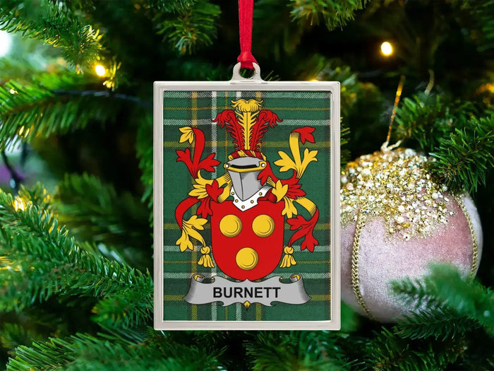 Burnett Irish family crest Christmas ornament — crest on the Irish national tartan in a silver-tone frame