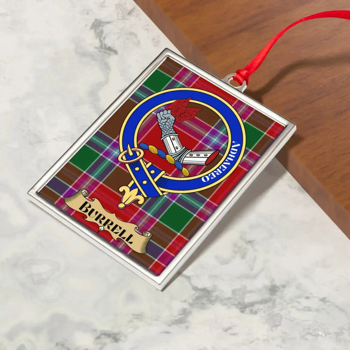 Burrell ornament hanging from a Christmas tree branch by its satin ribbon