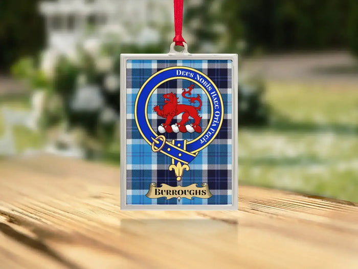 Close-up of the Burroughs family crest on a polished silver-frame metal ornament
