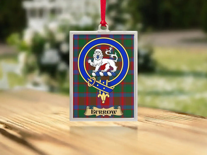 Close-up of the Burrow family crest on a polished silver-frame metal ornament