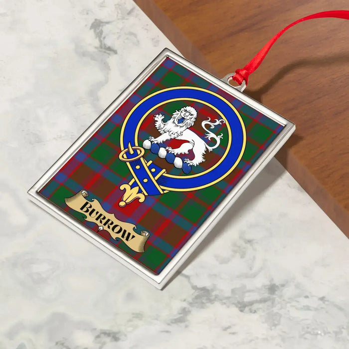 Burrow ornament hanging from a Christmas tree branch by its satin ribbon
