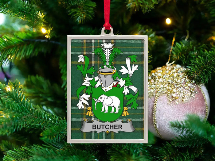Butcher Irish family crest Christmas ornament — crest on the Irish national tartan in a silver-tone frame