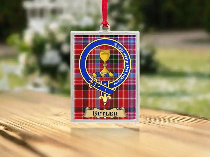 Close-up of the Butler family crest on a polished silver-frame metal ornament