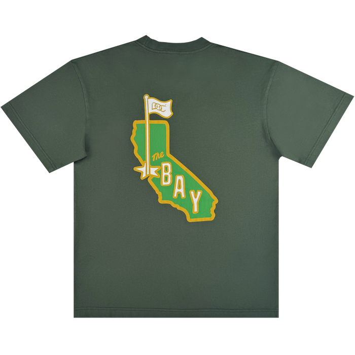 The CA Bay Area Tee by DOC from Oaklandish is a dark green heavyweight cotton shirt with a yellow outline of California and “The BAY” in bold lettering. A “1st” golf flag marks the Bay Area on the back.