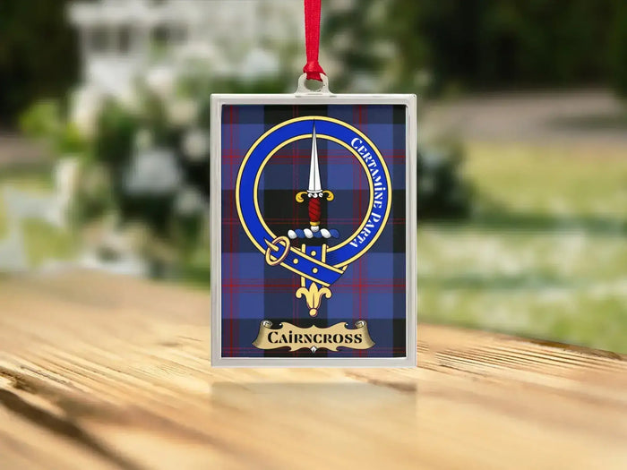 Close-up of the Cairncross family crest on a polished silver-frame metal ornament